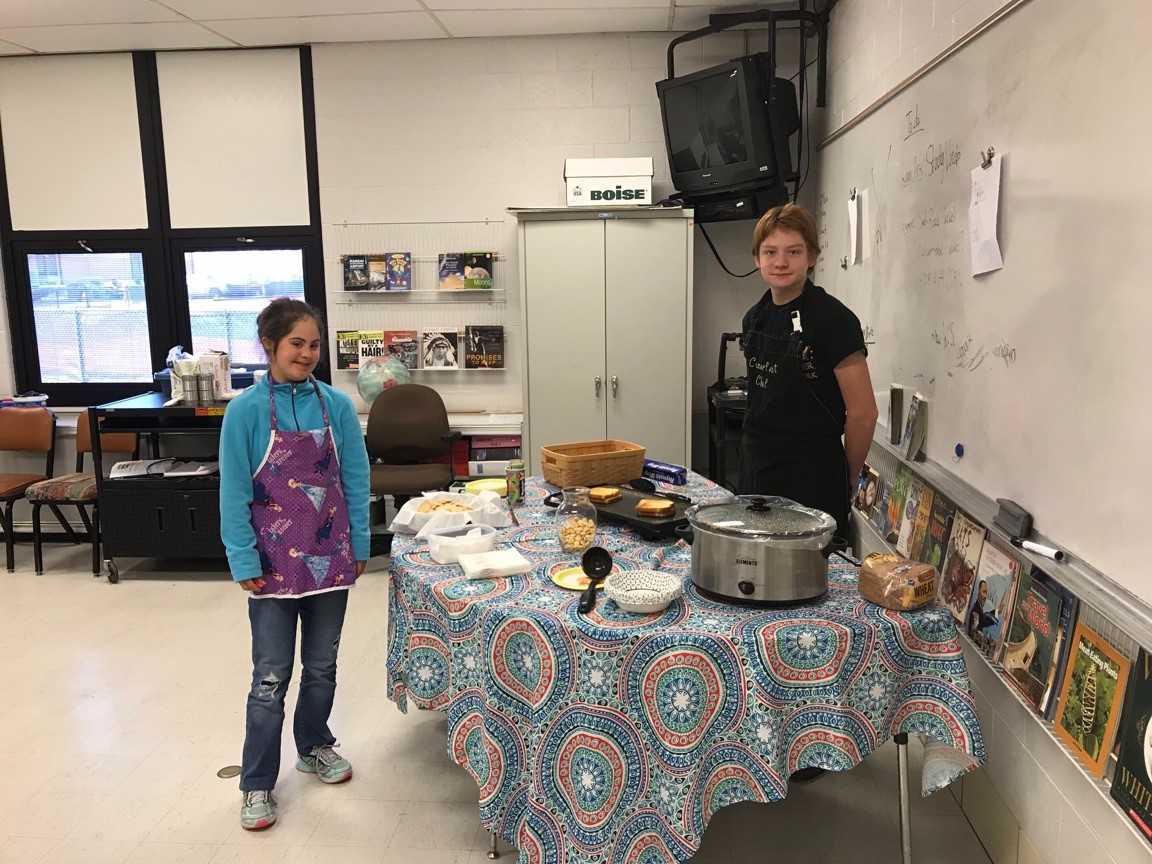 two students cooking food